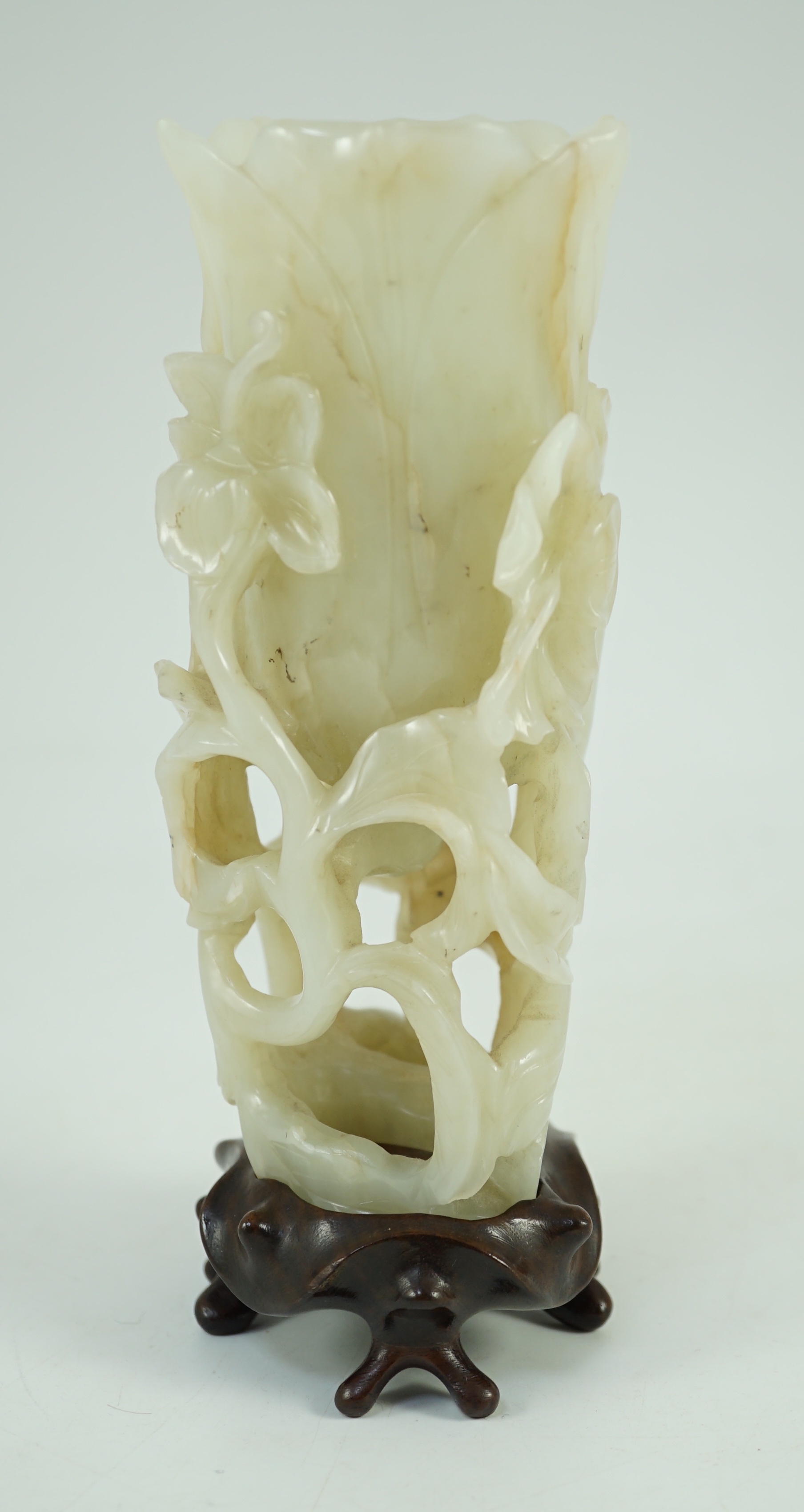 A large Chinese pale celadon jade ‘magnolia’ cup, 17th/18th century 17.5cm high excluding wood stand